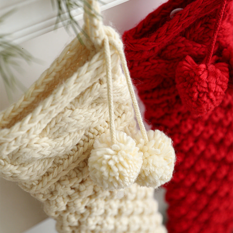 White knitted Christmas stocking hanging on a mantel